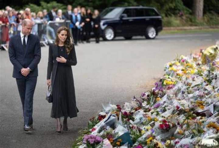 
Prince William, Kate Middleton View Memorial Flowers In First Solo Outing As Prince And Princess Of Wales 